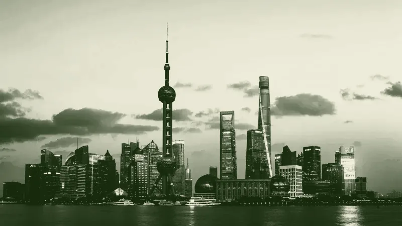 A city skyline at dusk seen across the water